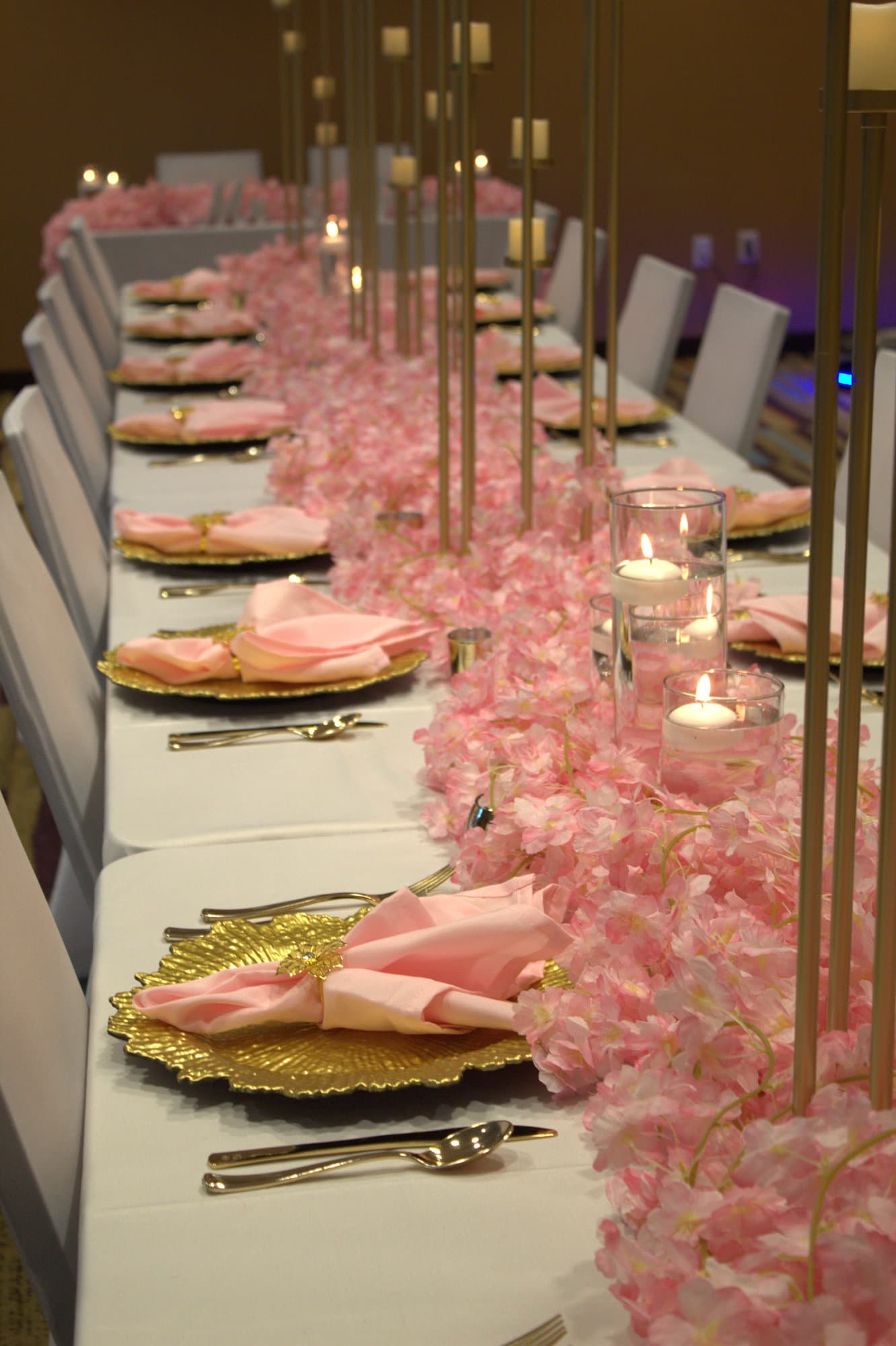 Long pink reception table with cherry blossom runner
